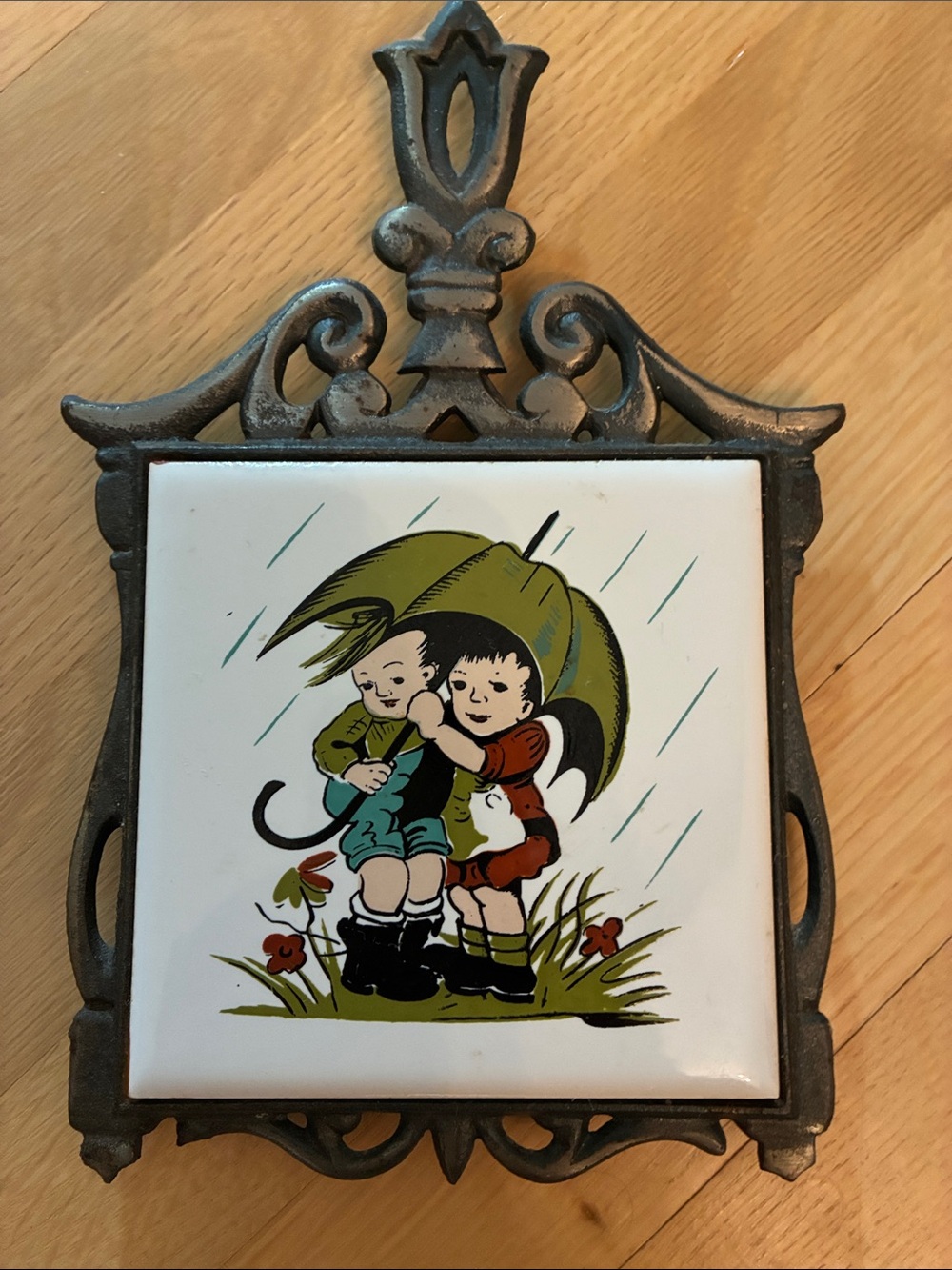 Vintage cast iron and ceramic tile kitchen trivet “Stormy Weather”
